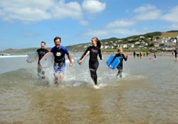 Family Running Beach Boards